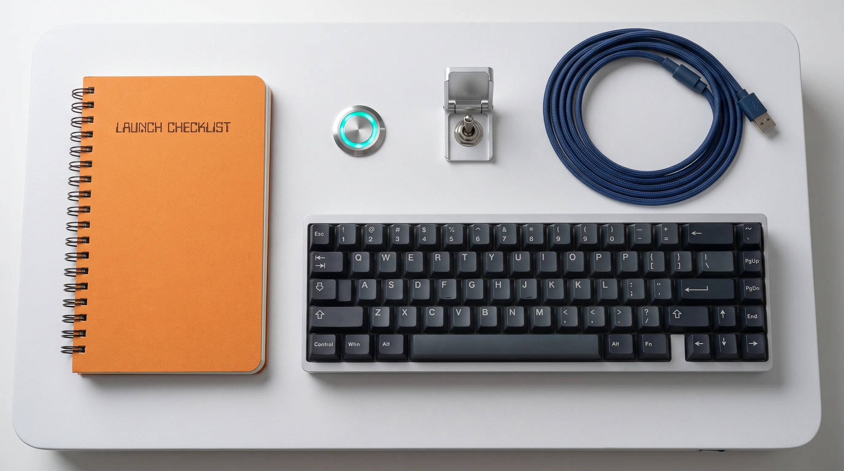 A launch checklist notebook beside a keyboard and console button
